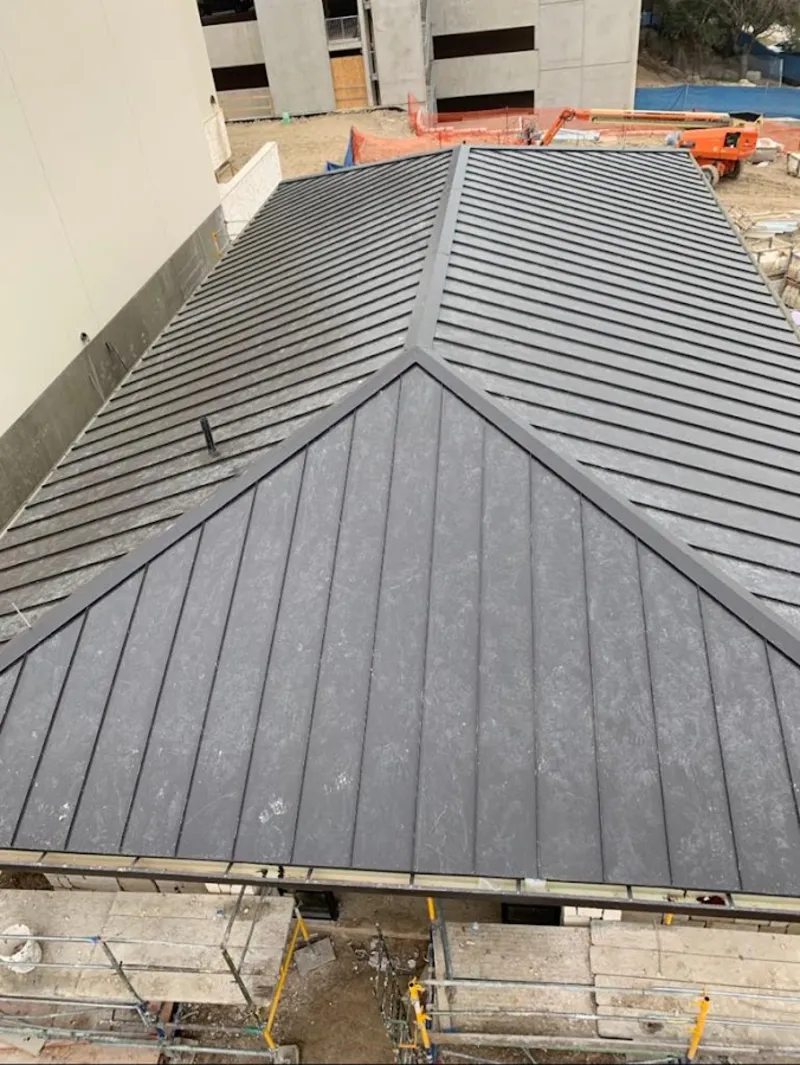 Commercial metal roof construction with crane equipment in Marlboro Village